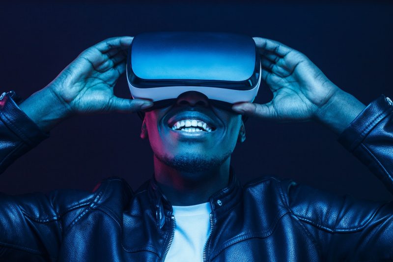 African man wearing virtual reality headset having great fun